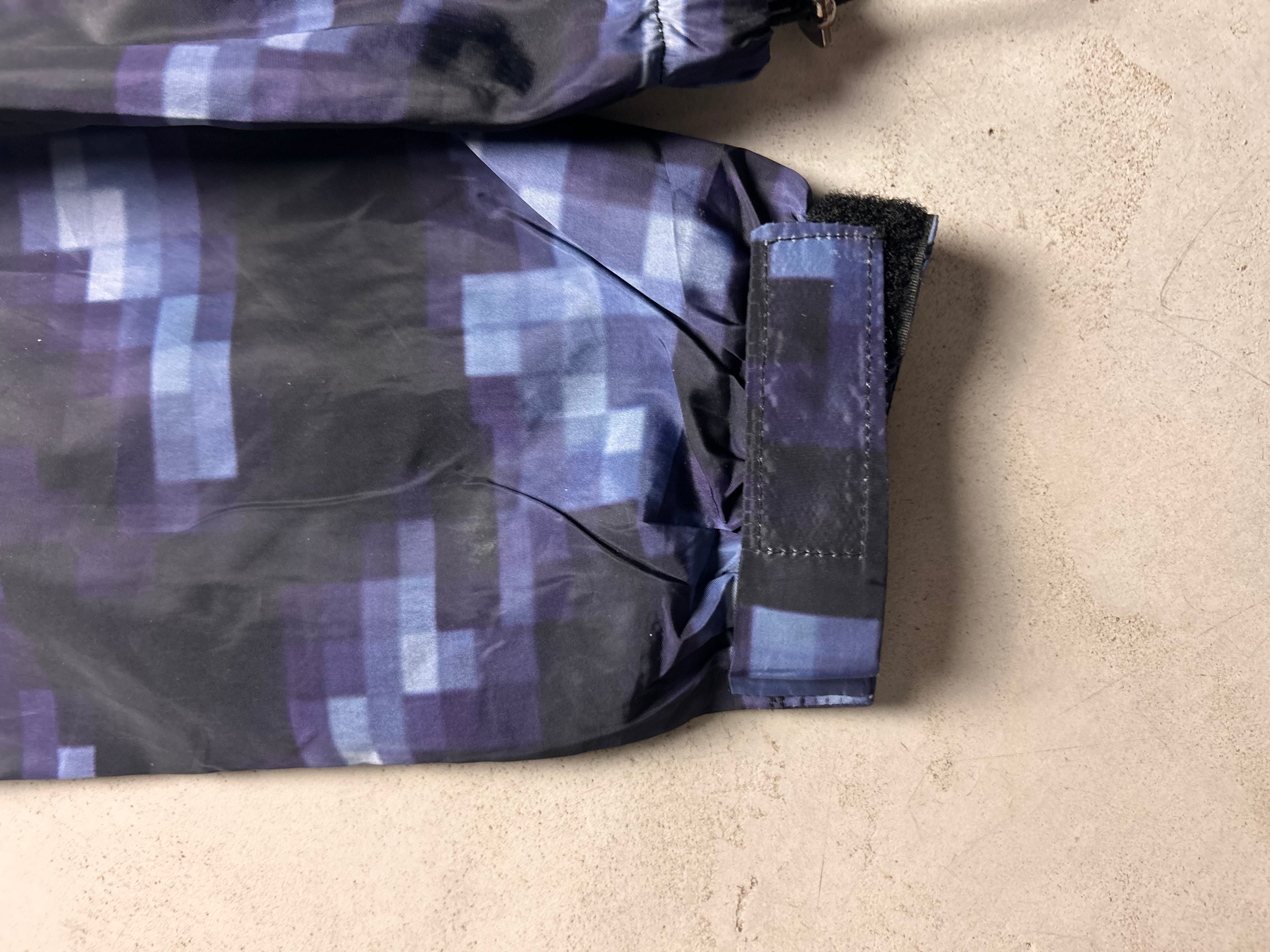 "GLITCHED" WINDBREAKER
